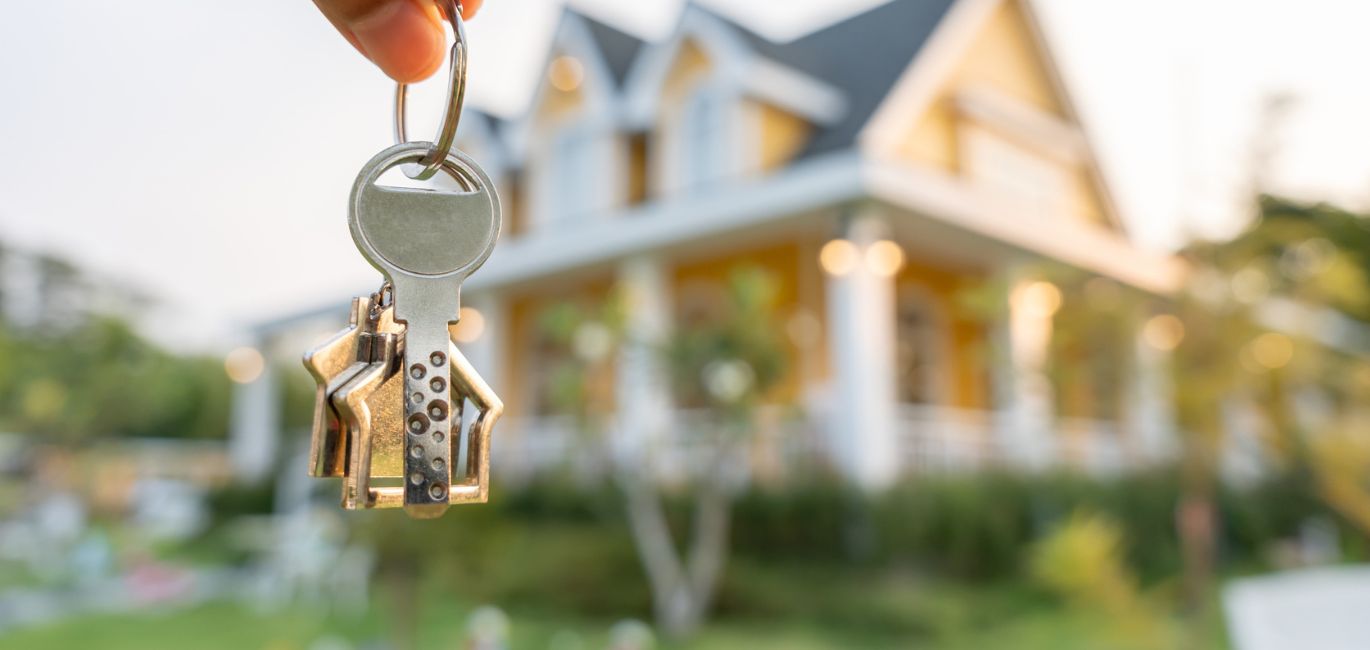 house keys in front of new home