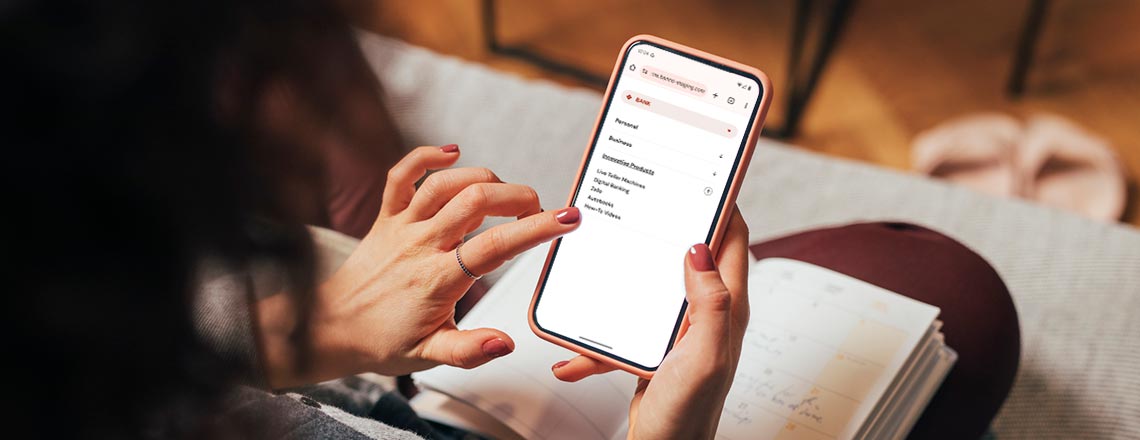 Person using their phone to navigate the menu on cs.bank