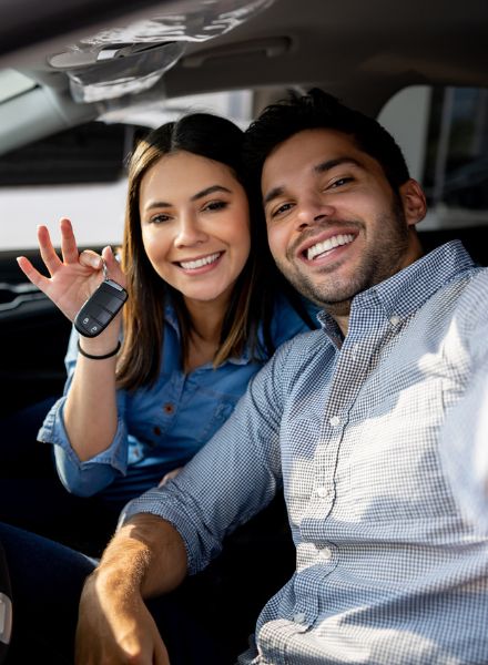 couple celebrating new car purchase