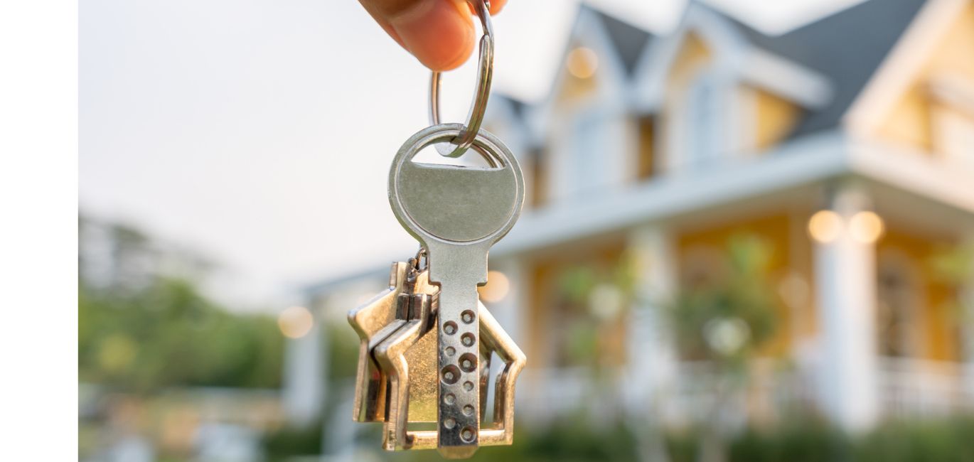 house keys in front of new home