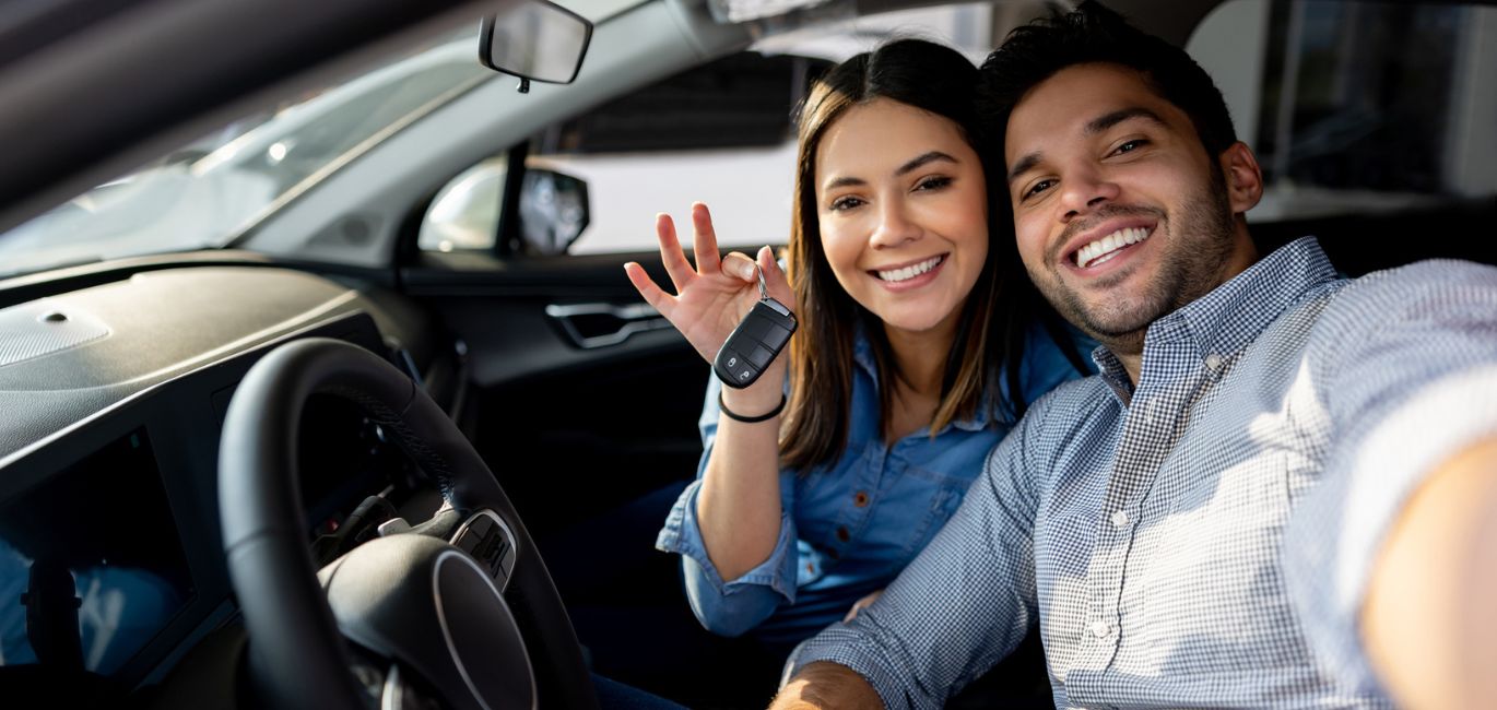 two people in a new car