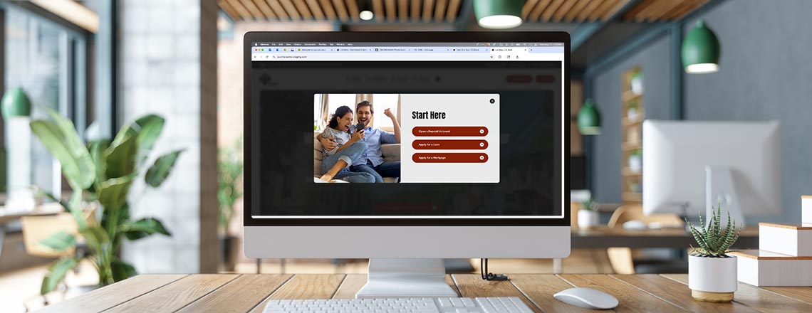 Computer on a desk displaying the start here modal on cs.bank