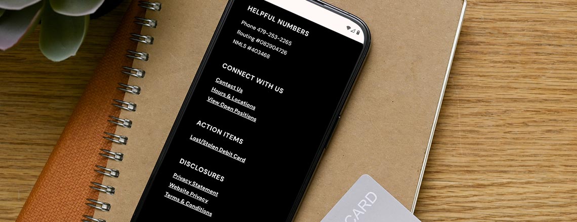 Phone showing cs.bank's website footer